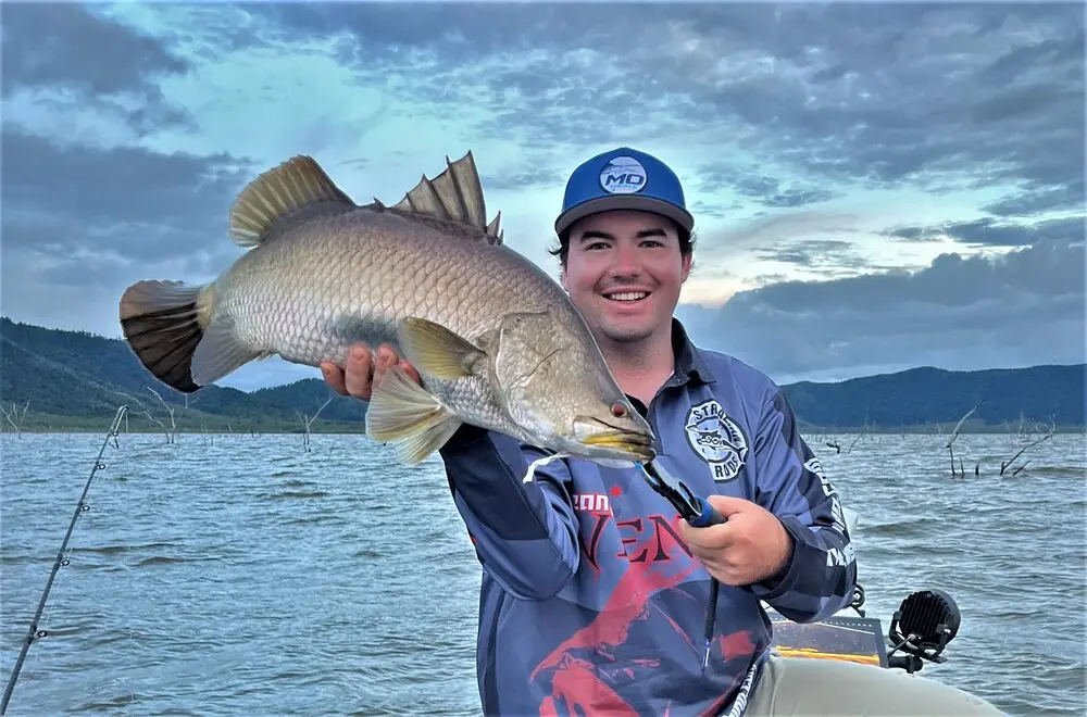 Cameron Hall shows off his first barra of the trip - monkey off the back moment!